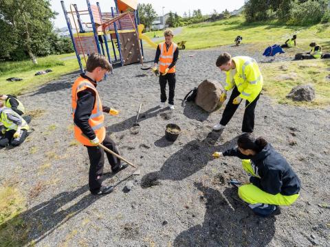 Children raking and performing cleanup work.