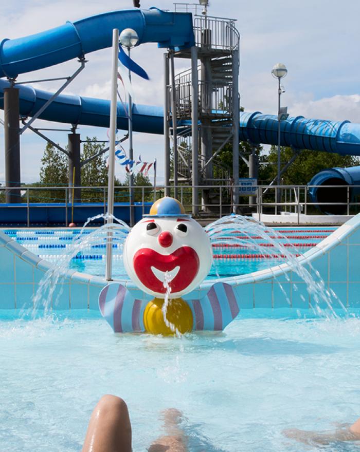 Large slide and clown fountain in children's wading pool at Grafarvogslaug