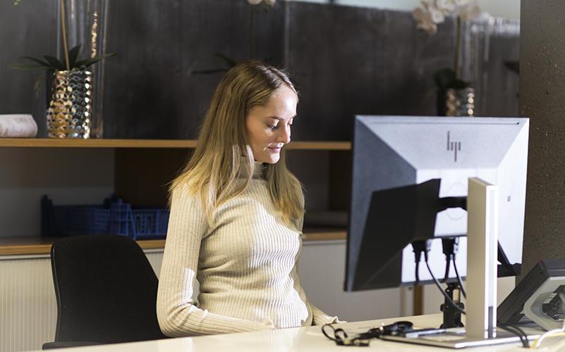 Service representative sits at their workstation.