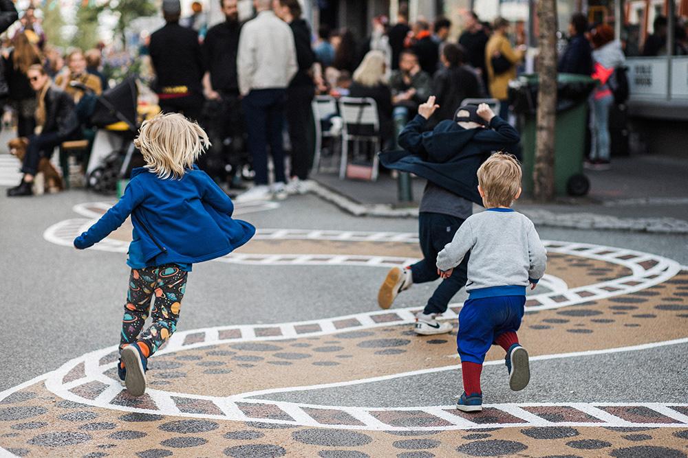 Kids playing on a pedestrian street.