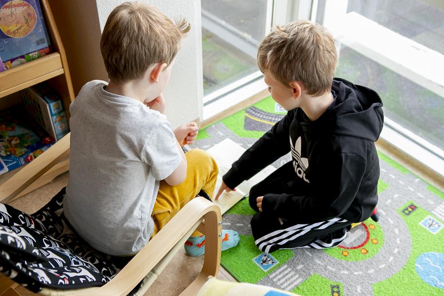 Children looking at a book at Brekkuborg preschool