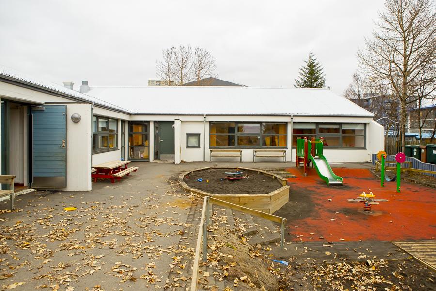 Sunnufold preschool and part of the outdoor grounds with slide, sandbox and other playground equipment 