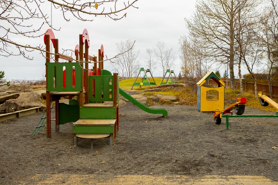 Playground castle with slide and small house on the outdoor grounds at Sunnufold preschool