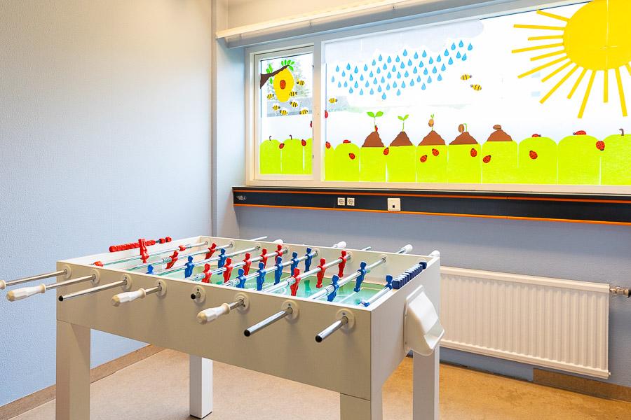 Foosball with decorated window in the background. 