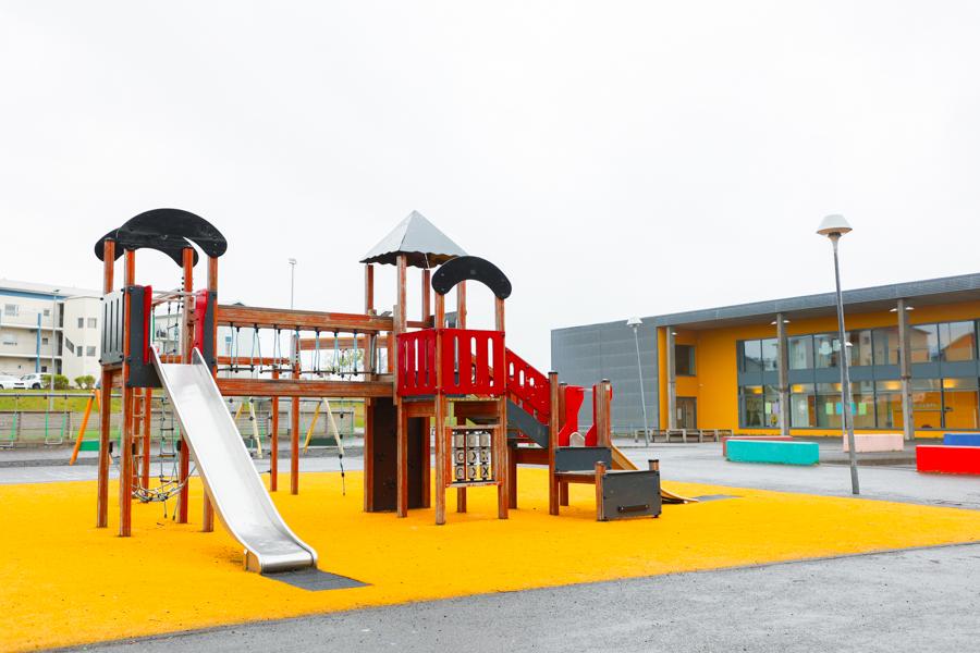 A playground castle with a slide on the school grounds.