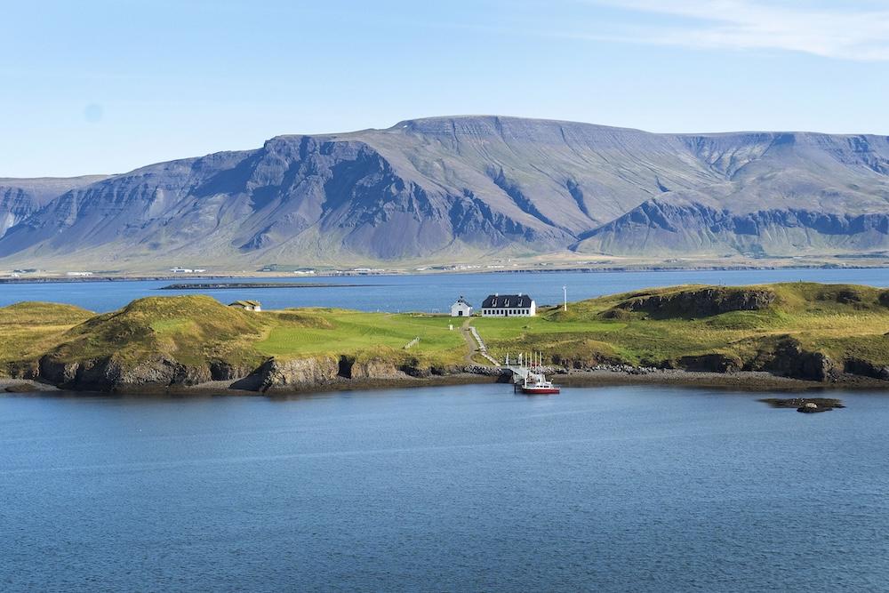 A view of Viðey, the sea, and Mount Esja.